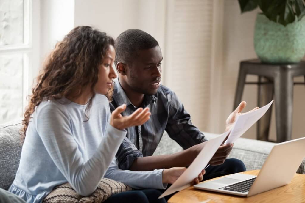 concerned couple looking at a document