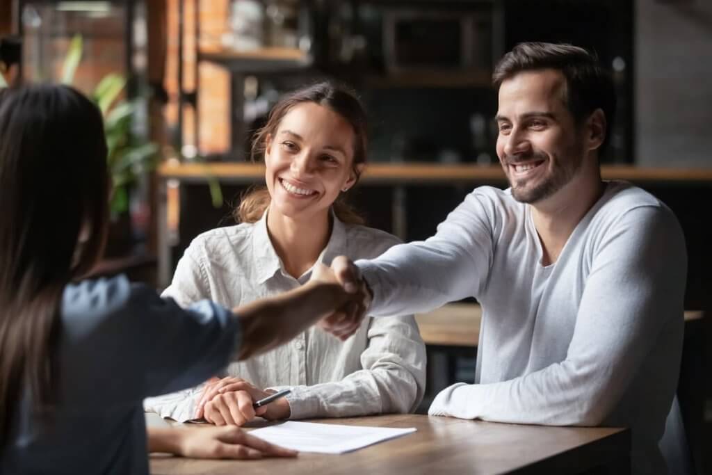 happy couple receiving house keys