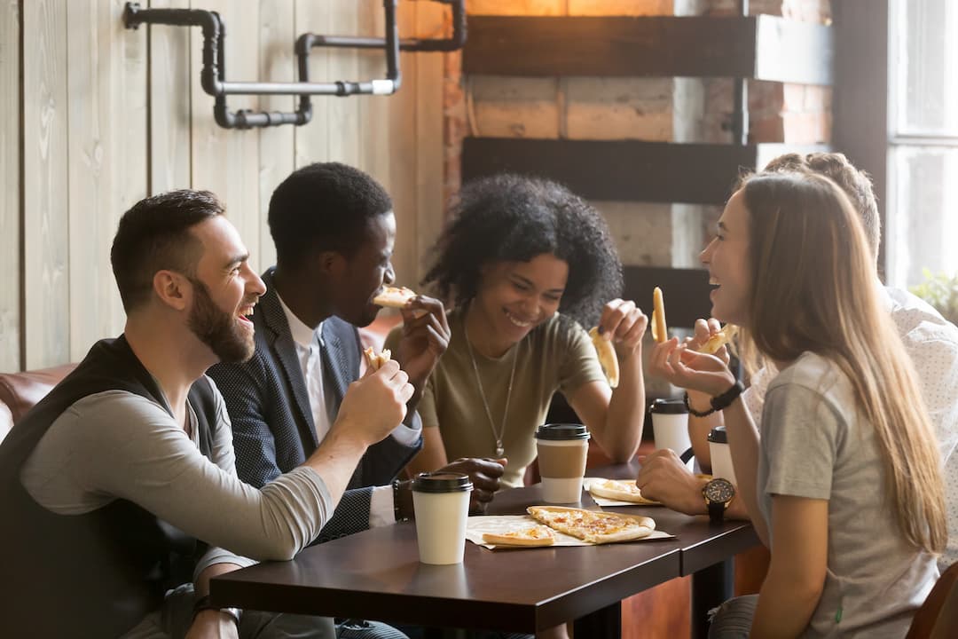 Young People Eating together in Pizzeria