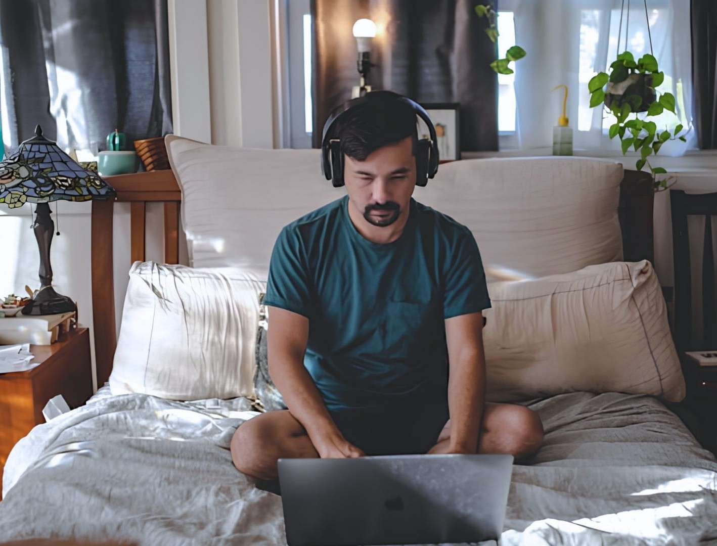 Student on a laptop on his bed