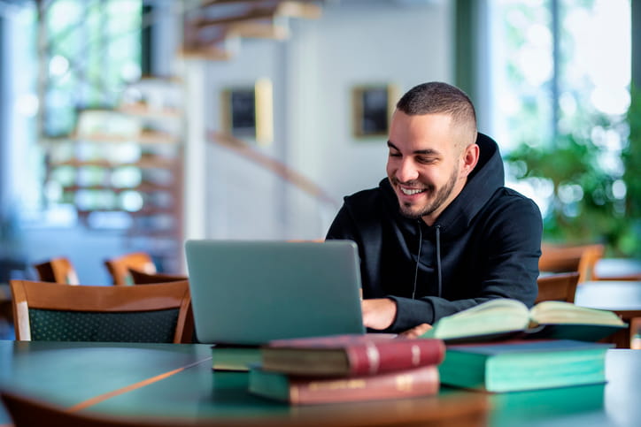 Student on laptop looking for accommodation