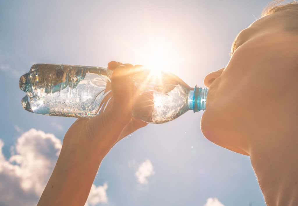 Young woman drinking a bottle of water