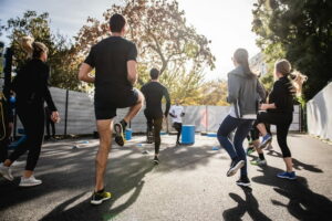 A group of people doing an exercise class outside