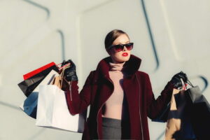 A woman holding multiple shopping bags in each hand