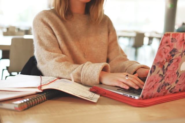 A female student working from home on her laptop