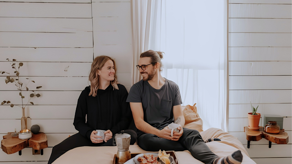 A couple sat on a bed