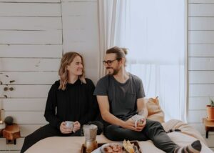 A couple sat on a bed