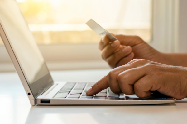 Student paying for something on a laptop