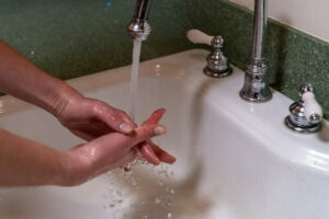 Hands being washed in a sink