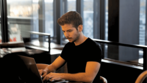 Student sorting bills on laptop