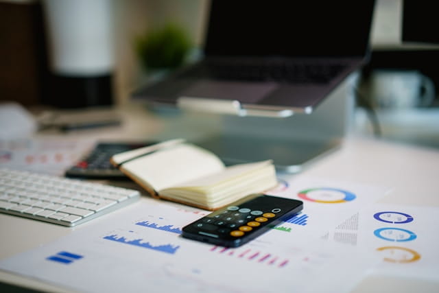 A calculator and papers on a table
