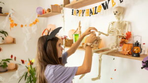 A female student decorating the house with Halloween decorations
